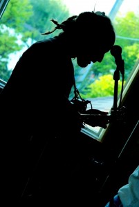 Emerging from the Shadows: Mandolinist Jason Wheeler of Fauxgrass at Rockford Brewing. (Photo/Kristine Carpenter)