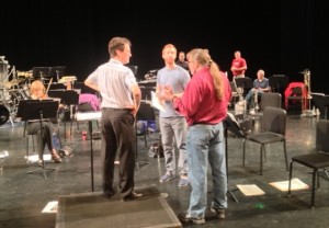 Conductor John Varineau, left, chats with composer Bill Hill during Thursday's rehearsal.