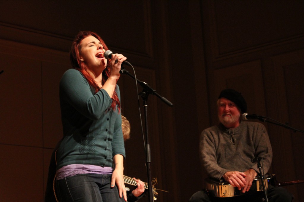 Fresh and Seasoned Folk: Bluesman Jimmie Stagger looks on as Hannah Rose Graves fires up the Royce Auditorium stage on Thursday. (Photo/Anna Sink)