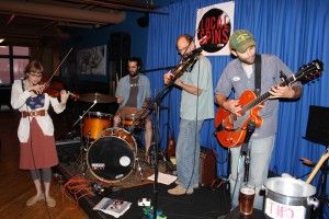 On Stage: Alexander Atkin, foreground, playing at SpeakEZ Lounge in June. (Photo/Taylor Mansen)