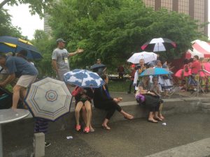 Umbrella Power: Fans and performers waited out showers during Festival Saturday evening. (Photo/Local Spins)